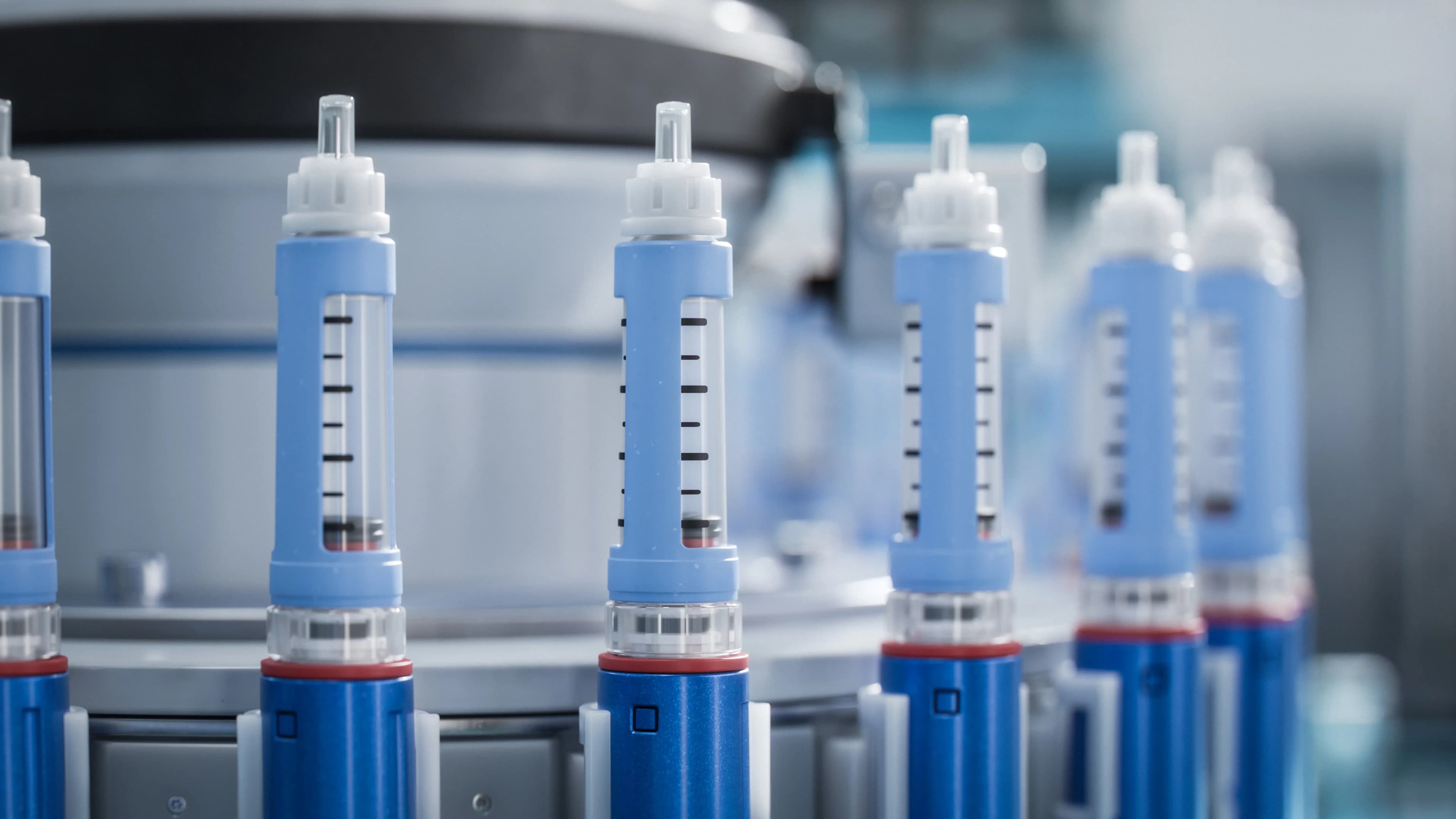 Rows of GLP-1 medication pens, used for employer benefits and coverage reporting.